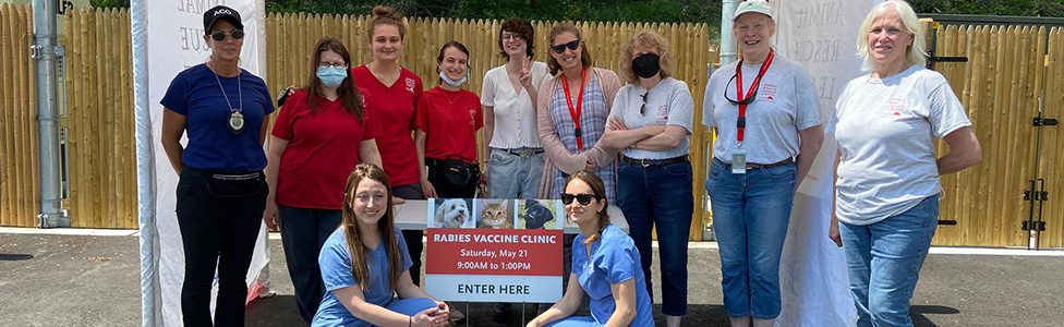 ARL staff posing with Rabies Clinic sign