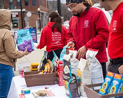 ARL staff hands out food at ABCD's pop up